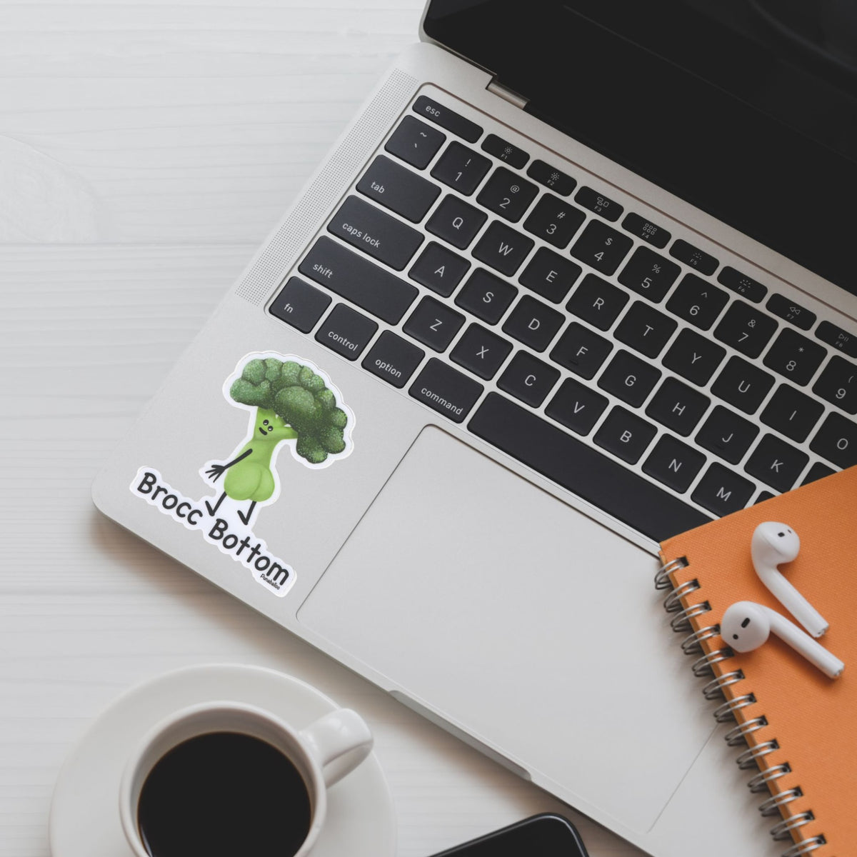 Brocc Bottom broccoli pun sticker displayed on a silver laptop