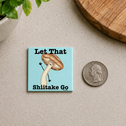 et That Shiitake Go mushroom pun magnet on a countertop beside a quarter for size