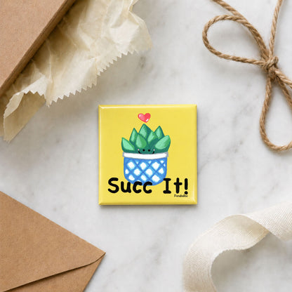 Funny plant magnet arranged with gift wrap, an envelope, ribbon, and twine