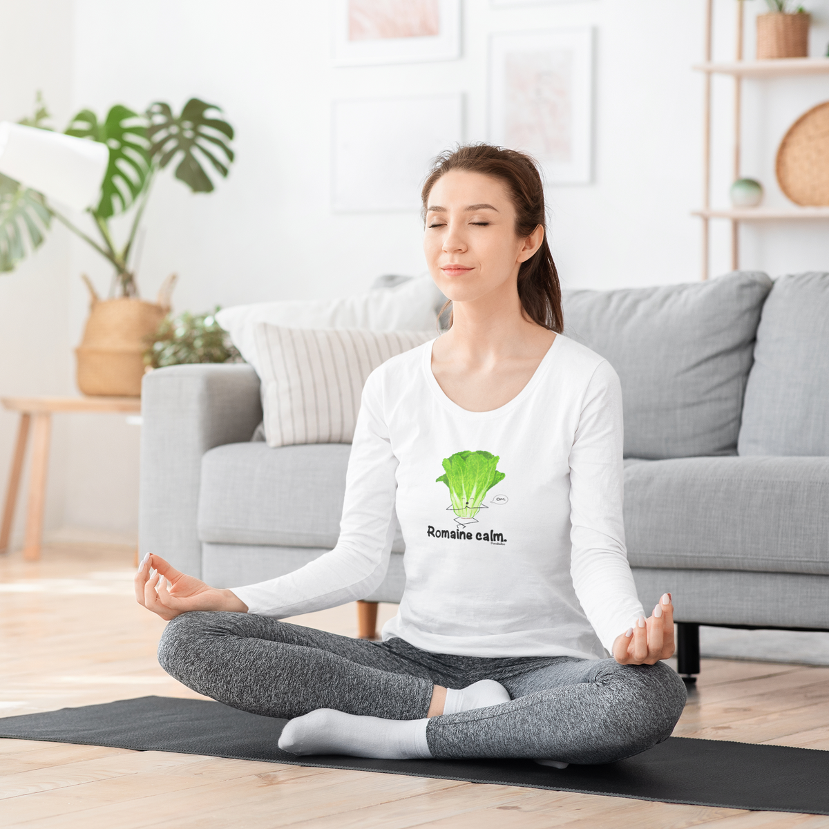 Woman meditating in a white Romaine Calm long sleeve shirt