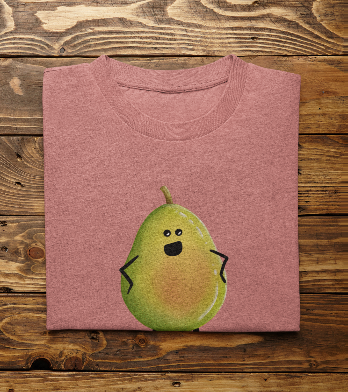 A folded heathered mauve t-shirt featuring a cute cartoon pear character printed on the front, displayed flat on a rustic wooden plank background.