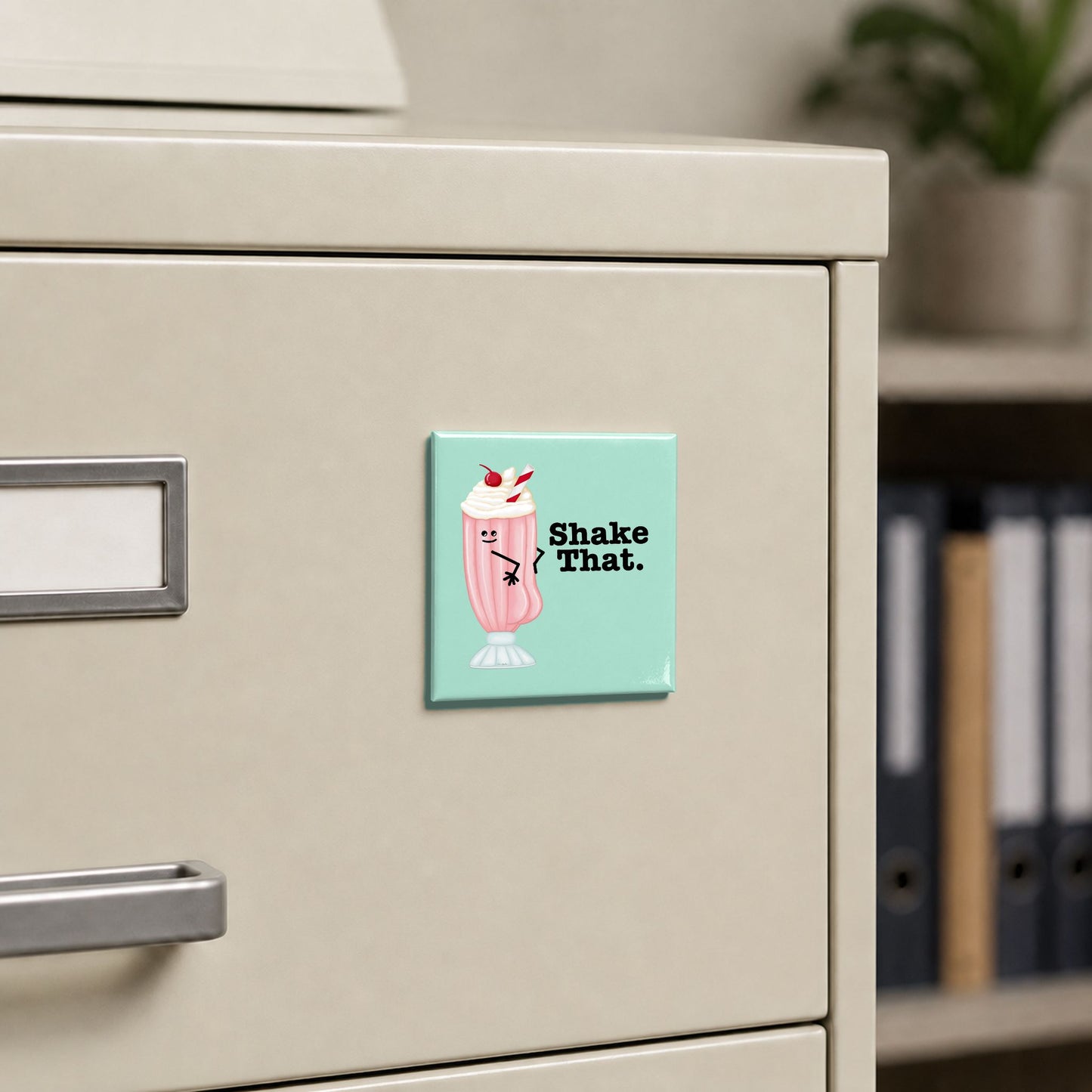 Shake That ice cream magnet displayed on a metal filing cabinet