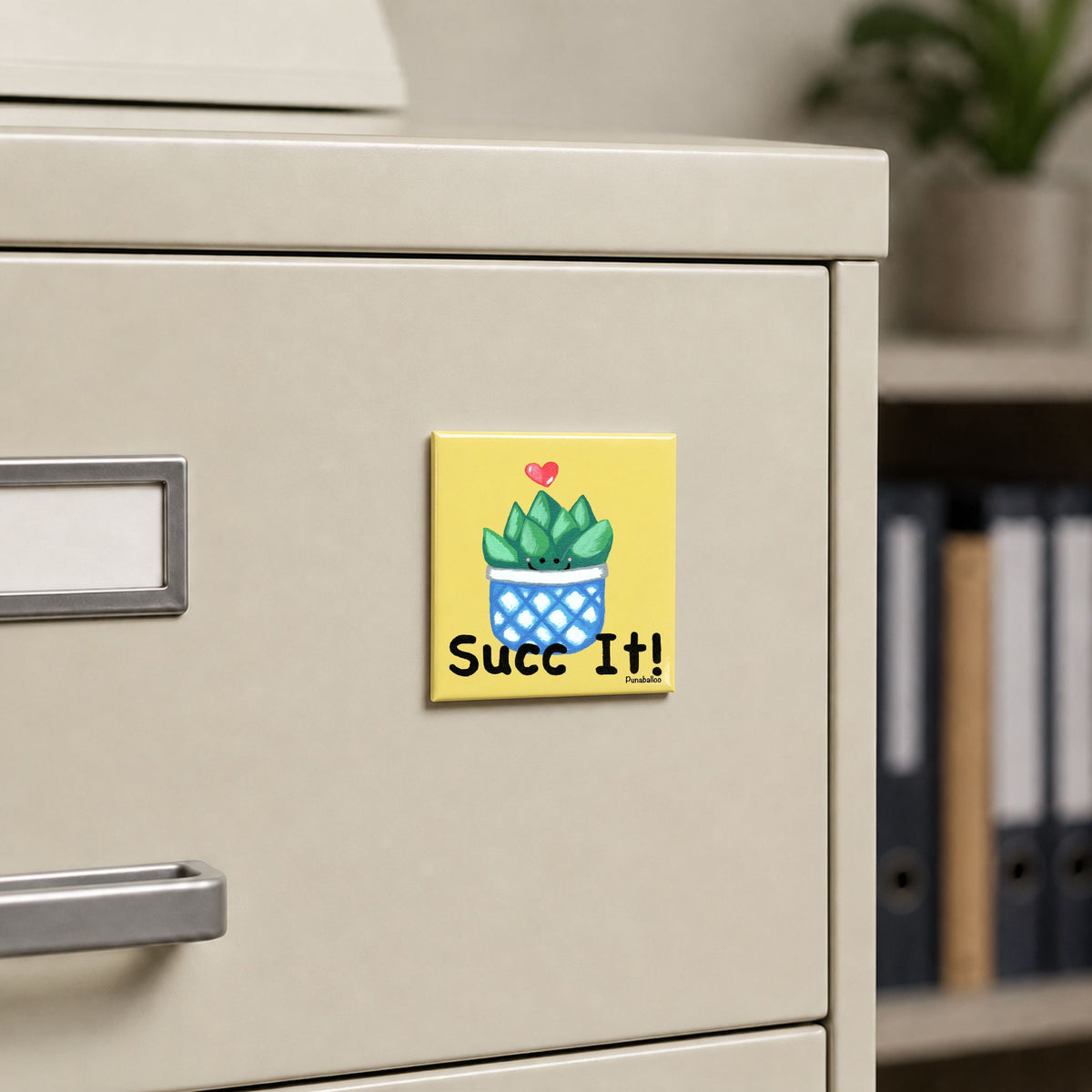 Succ It plant magnet displayed on a metal filing cabinet