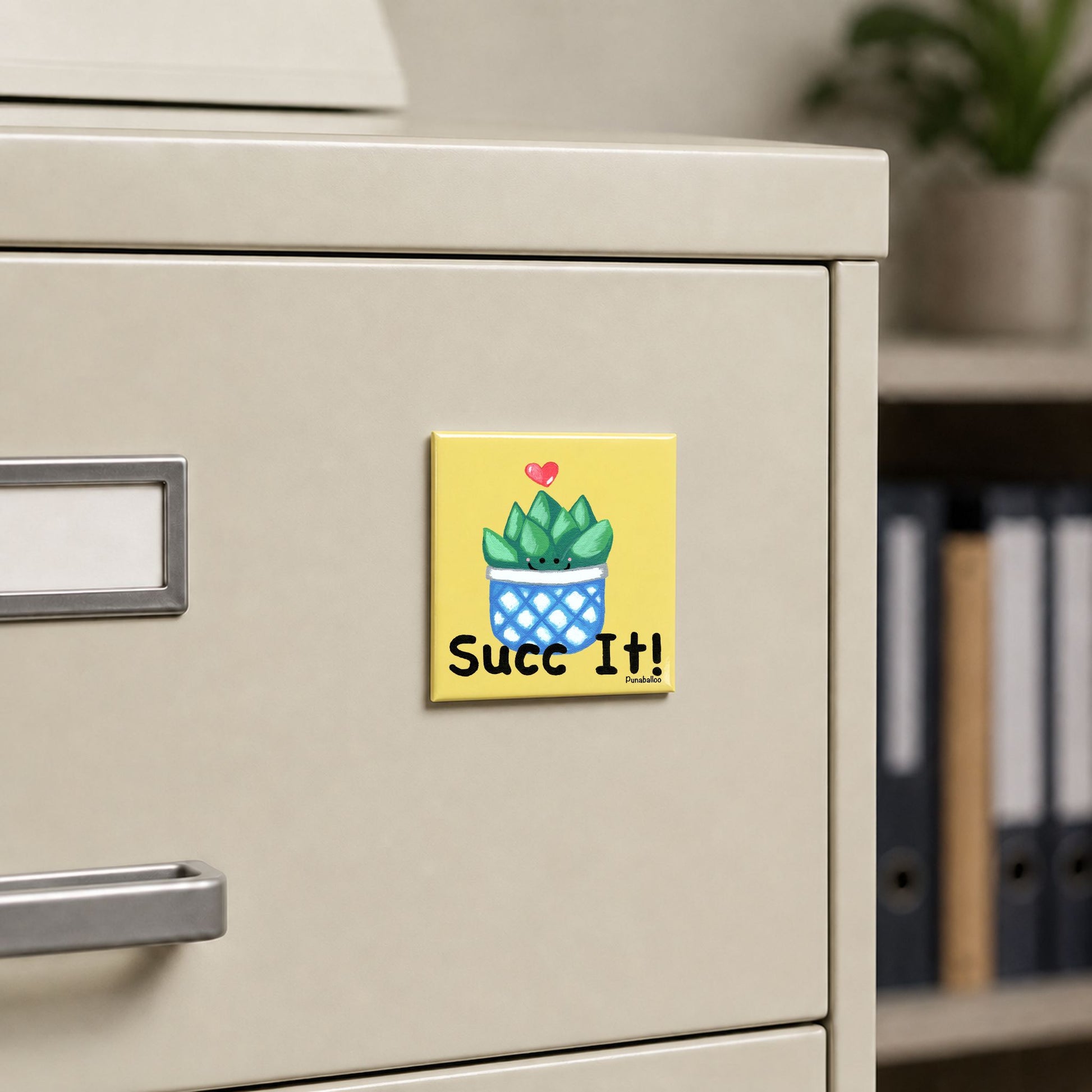 Succ It plant magnet displayed on a metal filing cabinet
