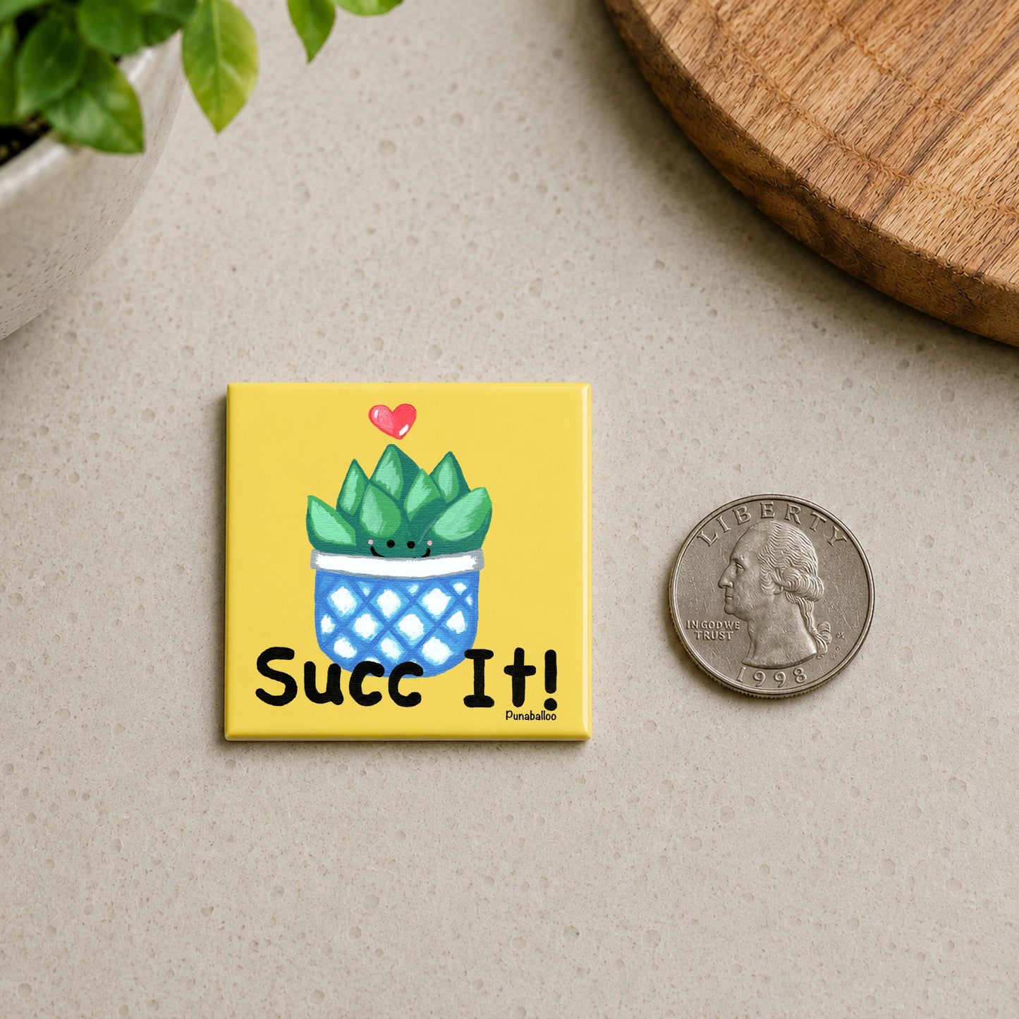 Succ It succulent magnet shown beside a quarter for scale