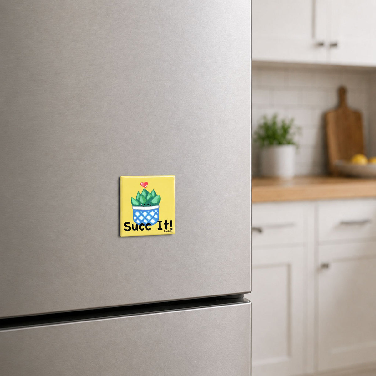 Succulent pun magnet on a stainless steel refrigerator in a bright kitchen