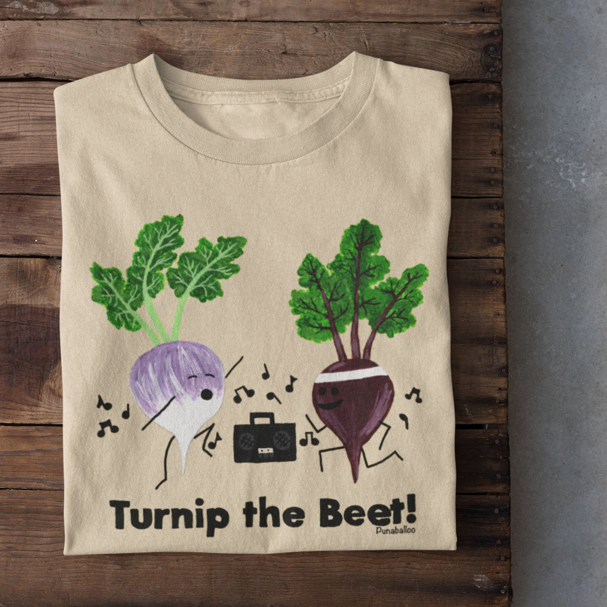 Soft Cream Turnip the Beet vegetable pun T-shirt folded on a rustic wood background