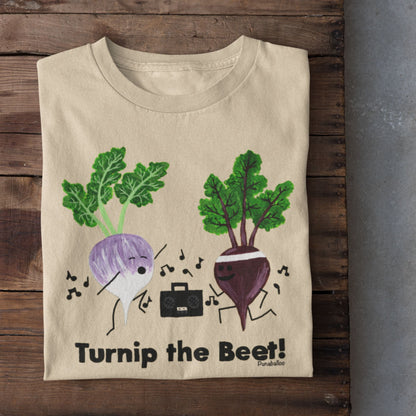 Soft Cream Turnip the Beet vegetable pun T-shirt folded on a rustic wood background