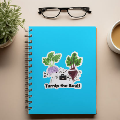 Turnip the Beet vegetable pun sticker displayed on a blue spiral notebook