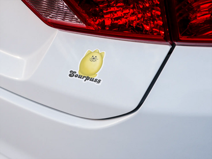Sourpuss fruit pun sticker on a white car bumper