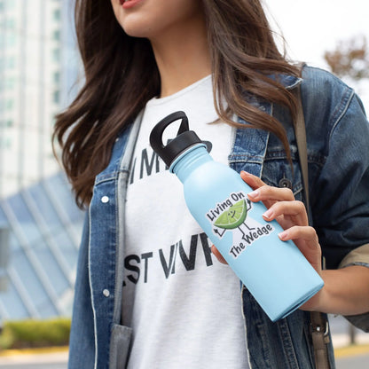 Woman holding a blue water bottle with a funny pun sticker featuring a lime character flipping the bird and the caption 'Living on The Wedge.'