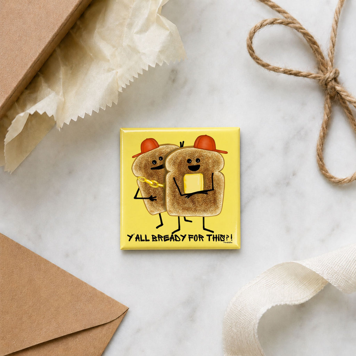 Y’all Bready magnet arranged with an envelope, tissue paper, ribbon, and twine