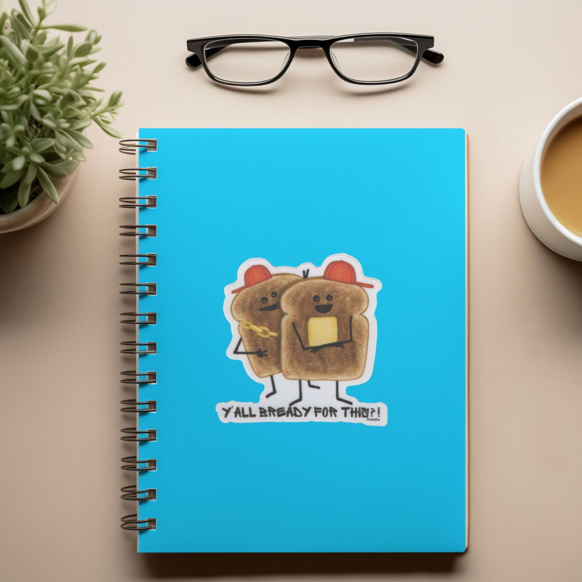 Funny toast sticker displayed on a bright blue spiral notebook