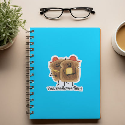 Funny toast sticker displayed on a bright blue spiral notebook